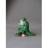 A Biscuit Figure of Bodhidharma in Meditation, Kangxi, the bearded figure seated in a long hooded