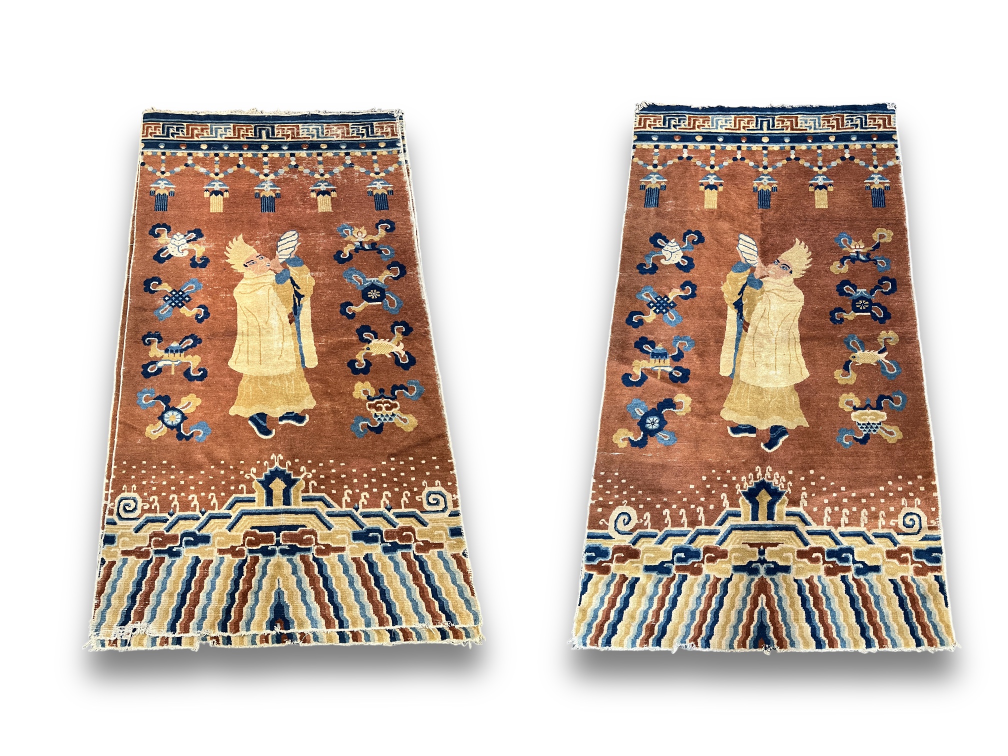 A Rare Pair of Buddhist Pillar Carpets, 18th/19th century, each with a yellow hat lama blowing a