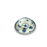 A blue and white Teacup and Saucer, Kangxi, well painted with clouds and roundels of cranes, the