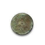 A Bronze Mirror, Warring States period, with finely moulded broad lozenge reserves enclosing