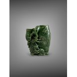 A spinach Jade 'deer and pine' Vase, 18th century, finely carved from the dark speckled stone in the