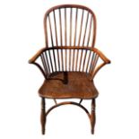 A 19TH CENTURY YEW WOOD AND ELM WINDSOR CHAIR The turned spindles back above solid shaped seat,