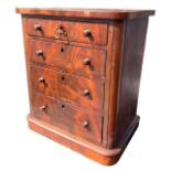 A 19TH CENTURY VICTORIAN FLAME MAHOGANY MINIATURE CHEST OF FOUR LONG GRADUATED DRAWERS With knob
