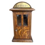 AN OAK MINIATURE APPRENTICE PIECE TABLE TOP LETTERBOX With dome top and brass plaque above a