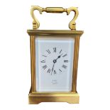 A 20TH CENTURY GILT METAL CARRIAGE CLOCK AND KEY White enamel dial with Roman numeral hour marks, ‘