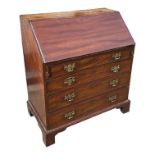 A GEORGE III MAHOGANY BUREAU The full front opening to reveal fitted interior and leather writing