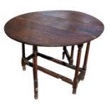 A SMALL 17TH CENTURY WILLIAM AND MARY OAK GATELEG TABLE The oval top support on eight turned gun