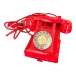 A 1950’S TYPE 300 SERIES RED BAKELITE TELEPHONE Impressed marks 164 - 67 to handset, exchange list