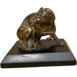 A SMALL 19TH CENTURY GILT BRONZE MODEL OF A SEATED PUG DOG WEARING DRAPERY Raised on a plinth