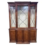 A 19TH CENTURY MAHOGANY BREAKFRONT LIBRARY BOOKCASE the top with four aster glazed doors opening to