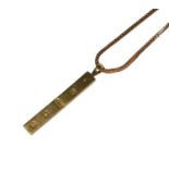 A 9CT GOLD INGOT PENDANT, HALLMARKED LONDON, 1976, ATTACHED TO A 9CT GOLD FOXTAIL LINK CHAIN. (