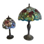 TWO 20TH CENTURY STAINED GLASS LAMPS Tiffany design, with mushroom form shades and filled bronze