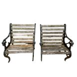 A PAIR OF REGENCY STYLE CAST IRON GARDEN ARMCHAIRS With pierced side and lion masks, on scroll feet.
