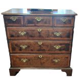 AN 18TH CENTURY WALNUT CHEST With three short above three long drawers fitted with brass