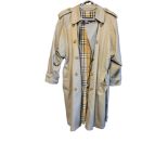 BURBERRYS, A VINTAGE LADIES’ TRENCH COAT Tan colour with traditional pattern to interior, bearing