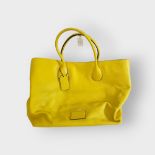 COACH, A YELLOW LEATHER HOLDALL SHOULDER BAG Having black leather piping and fabric shoulder