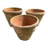 THREE LARGE TERRACOTTA PLANTERS With relief decoration of fruit. (57cm x 50cm) Condition: good