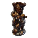 A VICTORIAN STAFFORDSHIRE TOBY JUG Brown treacle glaze modelled as the Snuff Taker. (approx 24cm)