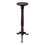 A GEORGIAN STYLE MAHOGANY TORCHÈRE The circular dish top on candy twist column terminating on