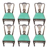 A SET OF SIX GEORGIAN STYLE MAHOGANY DINING CHAIRS With pierced vase splat backs and green fabric