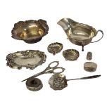 A COLLECTION OF VINTAGE SILVER TRINKETS Comprising a sauce boat, hallmarked Sheffield, 1937, a