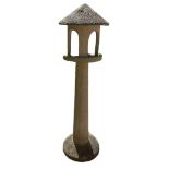 A RECONSTITUTED STONE BIRD TABLE With pergola top above a tapering column. (150cm) Condition: good