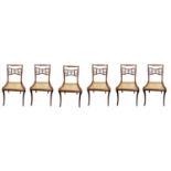 A SET OF SIX REGENCY PERIOD FAUX ROSEWOOD DINING CHAIRS Rope twists above pierced panels inset