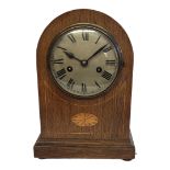 AN EDWARDIAN OAK CASED MANTEL/BEDSIDE CLOCK With silvered dial, Roman numerals, eight day