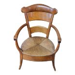 A 19TH CENTURY WALNUT OPEN ARMCHAIR With wide bar back and rush seat above deep apron, on splayed