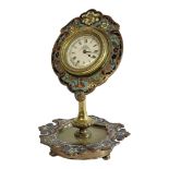 AN EARLY 20TH CENTURY BRASS, ENAMEL AND ONYX TABLE CLOCK Scrolled case with champleve enamel