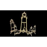 A COLLECTION OF FIVE 20TH CENTURY BRASS EASEL PICTURE STANDS Scrolled Rococo form. (largest approx