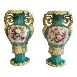 A PAIR OF 19TH CENTURY PORCELAIN VASES Twin handles with hand painted decoration on green ground. (