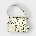 LULU GUINNESS, A MEDIUM BLACK AND WHITE LEATHER ANNIE HANDBAG With gilt brass lips clasp and