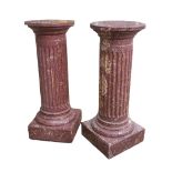 A PAIR OF 19TH CENTURY STYLE FAUX ROUGE MARBLE PLINTHS the circular tops on fluted columns with