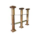 A OPEN SET OF PINE SHELVES IN THE FORM OF THREE DORIC COLUMNS Divided by glass panels. (120cm x 33cm