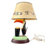 ADVERTISING INTEREST, A CARLTON WARE GUINNESS TOUCAN TABLE LAMP MODELLED WITH A TOUCAN STANDING