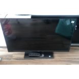 A TOSHIBA TELEVISION ON STAND. (92cm x 55cm)