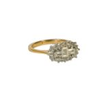 AN 18CT YELLOW GOLD DIAMOND CLUSTER RING, set with round brilliant cut and baguette cut diamonds. (