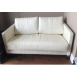 AN ART DECO STYLE TWO SEAT SOFA BED In a cream button back faux crocodile skin upholstery (141cm x