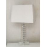 A PAIR OF BLOCK GLASS TABLE LAMPS With cream shades. (65cm) Condition: good