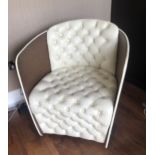 AN ART DECO STYLE TUB ARMCHAIR With aluminium clad frame, upholstered in a cream button back faux