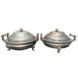 A PAIR OF CHINESE PEWTER WARMING DISHES Having twin stylised peacock handles, lids decorated with