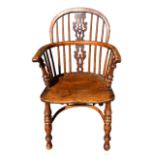 A 19TH CENTURY YEW WOOD AND ELM WINDSOR CHAIR The pierced splat and turned spindles above solid