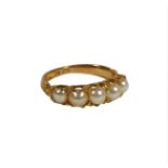 A VICTORIAN 18CT GOLD AND FIVE PEARL RING having chased and engraved ornate shoulders. (UK ring size