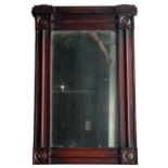 A 19TH CENTURY REGENCY MAHOGANY PIER MIRROR The central glass surrounded by four circular