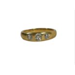 A YELLOW METAL, THREE STONE DIAMOND RING, YELLOW METAL TESTED AS 14CT GOLD The central diamond old