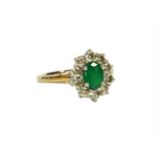 A 9CT WHITE AND YELLOW GOLD, EMERALD AND DIAMOND CLUSTER RING. (Approx Emerald 0.85ct. Diamonds 0.
