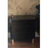 A PAIR OF BLACK FINISH BEDSIDE CHESTS With three drawers and canted corners. (65cm x 40cm x 71cm)