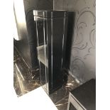 A PAIR OF BLACK LACQUERED PEDESTAL PLINTHS/PLANTERS The removable tops concealing glass vases. (31cm