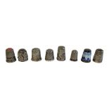A COLLECTION OF VINTAGE SILVER AND WHITE METAL SEWING THIMBLES Comprising a thimble with enamel